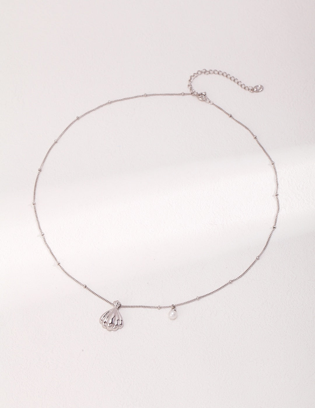 Pendant of shell and pearl necklaces