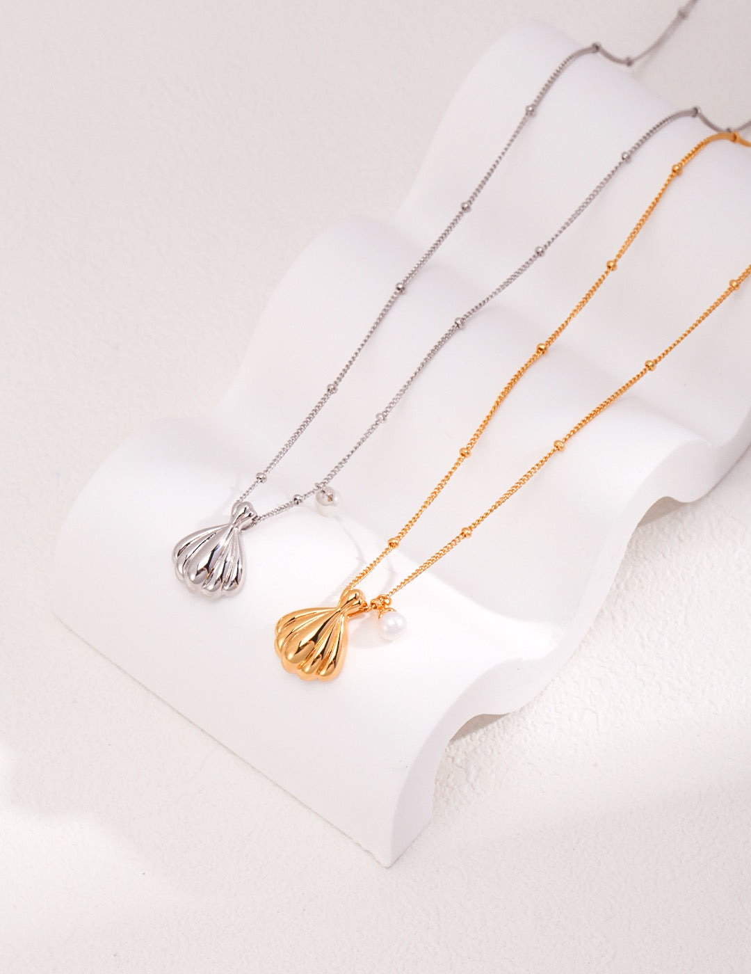 Pendant of shell and pearl necklaces