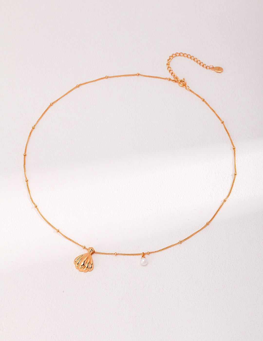 Pendant of shell and pearl necklaces